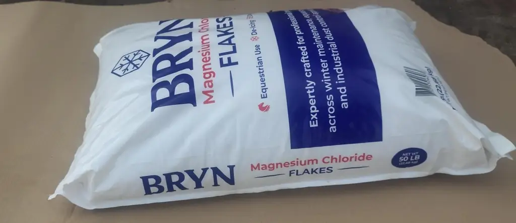A 50 lb bag of Bryn magnesium chloride flakes photographed on cardboard